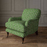 Armchair covered in a linen fabric with a hand block-style pattern in green, black and cream
