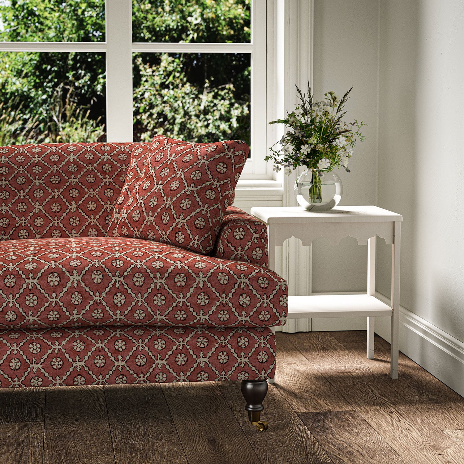 Sofa covered in a linen fabric with a hand block-style pattern in red, black and cream