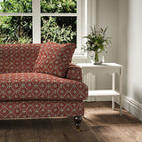 Sofa covered in a linen fabric with a hand block-style pattern in red, black and cream