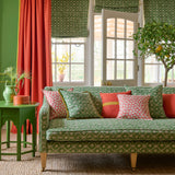 Sofa covered in a linen fabric with a hand block-style pattern in green, black and cream