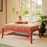 Bamboo footstool covered in orange and green printed velvet featuring an irregular diamond motif.