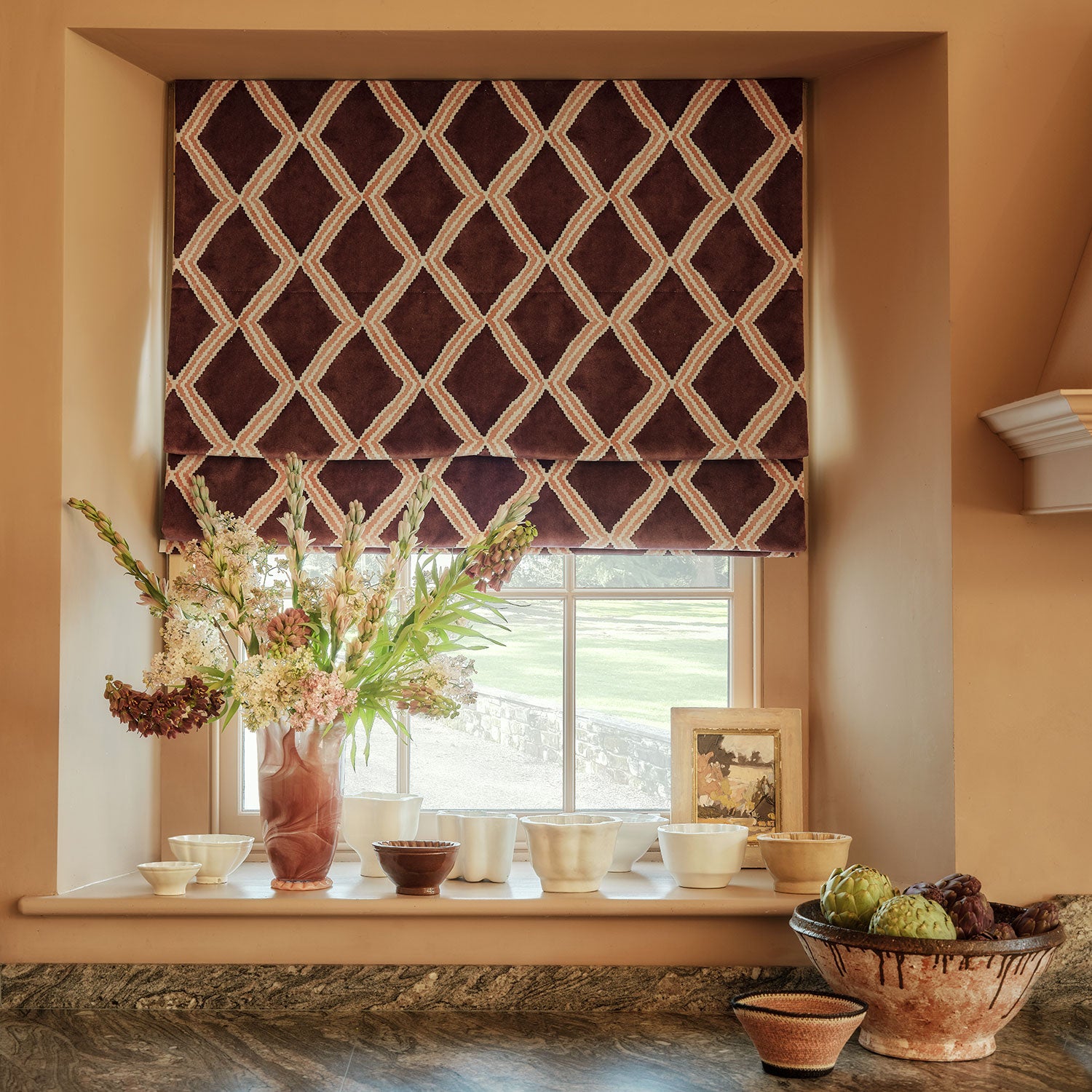 Luxurious blind in maroon and pink printed velvet featuring an irregular diamond motif.