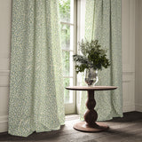 Curtains made from a printed linen fabric in blue, green, and off white featuring a feel of a classic animal print.