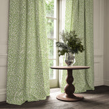 Curtains made from a printed linen fabric in green and off white featuring a feel of a classic animal print.
