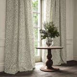 Curtains made from a printed linen fabric in black, grey, and off white featuring a feel of a classic animal print.
