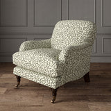 Armchair upholstered in a printed linen fabric in black, grey,  and off white featuring a feel of a classic animal print.