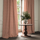 Curtains made from a printed linen fabric in red and off white featuring a Japanese print.