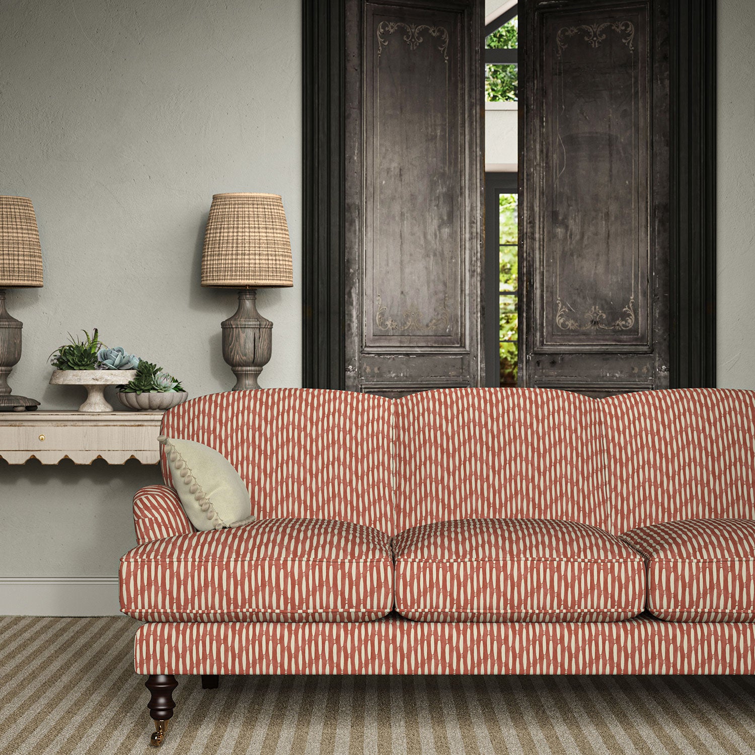 Sofa upholstered in a printed linen fabric in red and off white featuring a Japanese print.