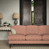 Sofa upholstered in a printed linen fabric in red and off white featuring a Japanese print.