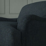 Close up of armchair in Loxley Indigo by Linwood – durable, Italian-woven natural fibre fabric in deep blue.