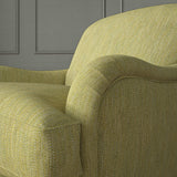 Close-up of armchair in Loxley Lime by Linwood – durable, Italian-woven natural fibre fabric in green.
