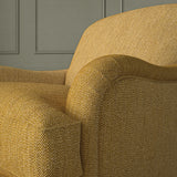 Close-up of armchair in Loxley Ochre by Linwood – durable, Italian-woven natural fibre fabric in rich mustard yellow.