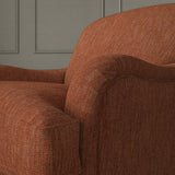 Close-up of armchair in Loxley Redwood by Linwood – durable, Italian-woven natural fibre fabric in deep russet.