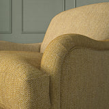Close-up of armchair in Loxley Sand Dune by Linwood – durable, Italian-woven natural fibre fabric in soft beige.