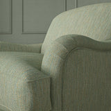 Close-up of armchair in Loxley Seagreen by Linwood – durable, Italian-woven natural fibre fabric in muted green.