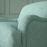 Close-up of armchair in Loxley Sky by Linwood – durable, Italian-woven natural fibre fabric in muted blue.