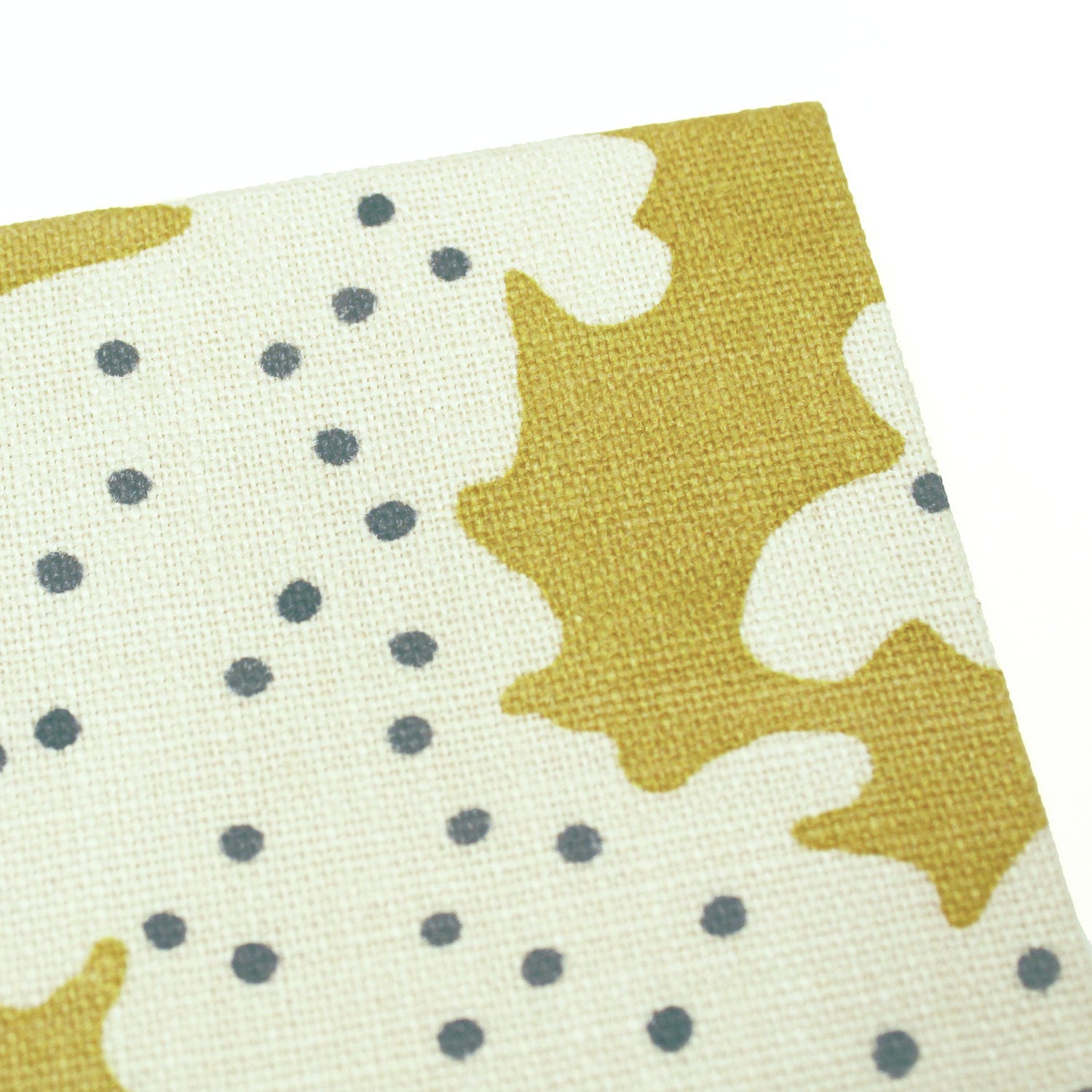 A yellow and cream linen notebook with a stylized coral pattern.