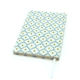 A blue, yellow, cream linen notebook with a classic trellis pattern.
