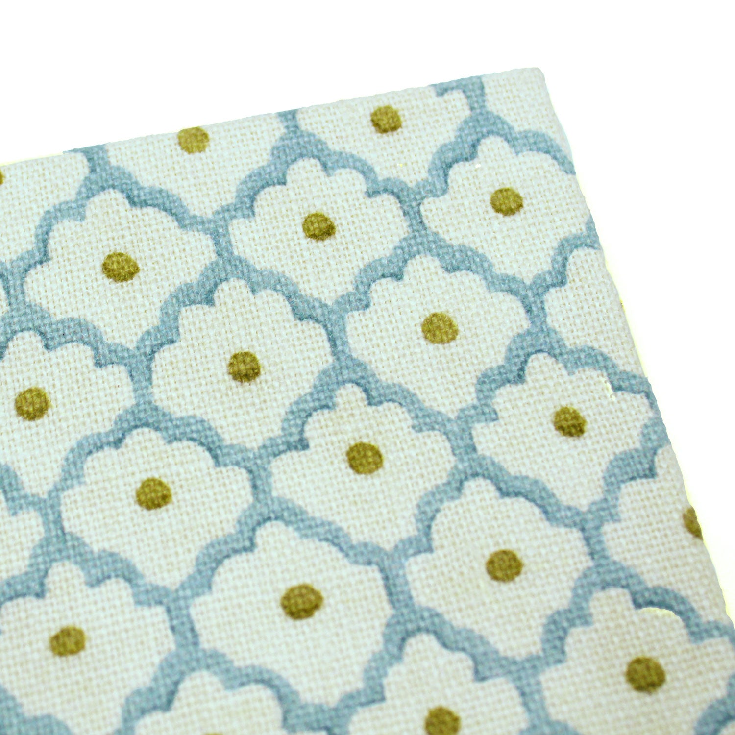 A blue, yellow, cream linen notebook with a classic trellis pattern.