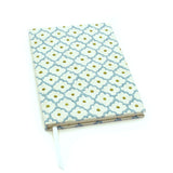 A blue, yellow, cream linen notebook with a classic trellis pattern.