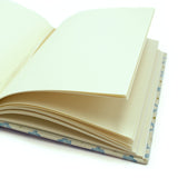 A blue, yellow, cream linen notebook with a classic trellis pattern.