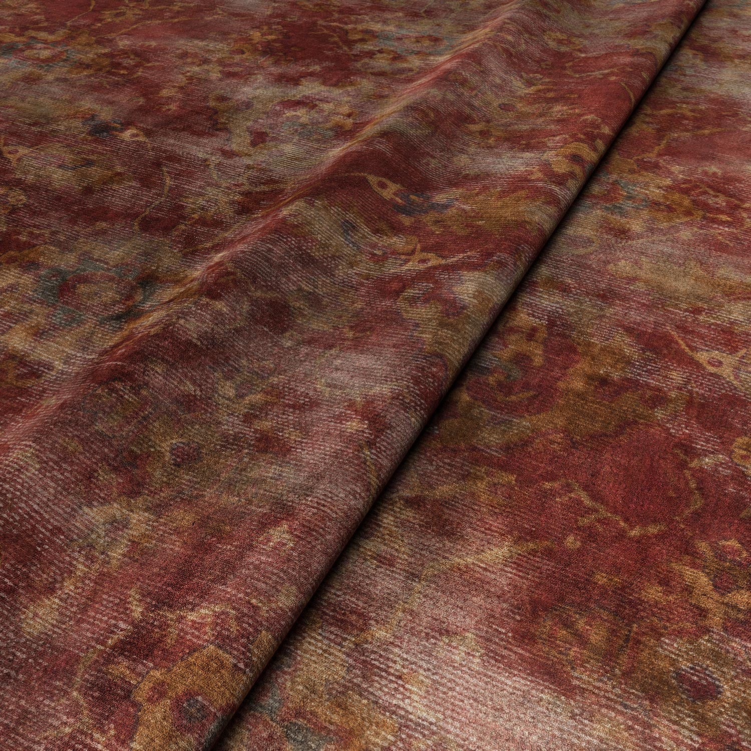 A printed velvet fabric sample in red and brown featuring a classic distressed pattern.