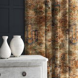 A curtain made from a printed velvet fabric in brown and black featuring an opulent pattern.