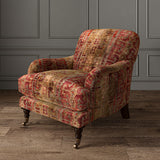 Armchair upholstered in a printed velvet fabric in red and brown featuring a stripe kilim pattern.