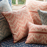 Cushions made from a printed linen fabric in orange, blue, and off white featuring a Japanese print.