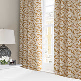 Curtains made from a printed linen fabric sample in orange, blue and off white featuring a stylized coral pattern.