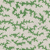 A printed linen fabric sample in green, black and off white featuring a stylized coral pattern.