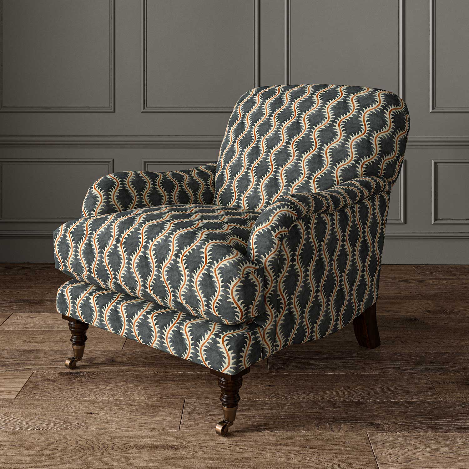 Chair upholstered in a printed linen fabric sample in blue, orange and off white featuring a stylized fern pattern.