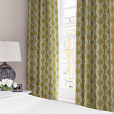 Curtains made from a printed linen fabric sample in yellow, blue and off white featuring a stylized fern pattern.