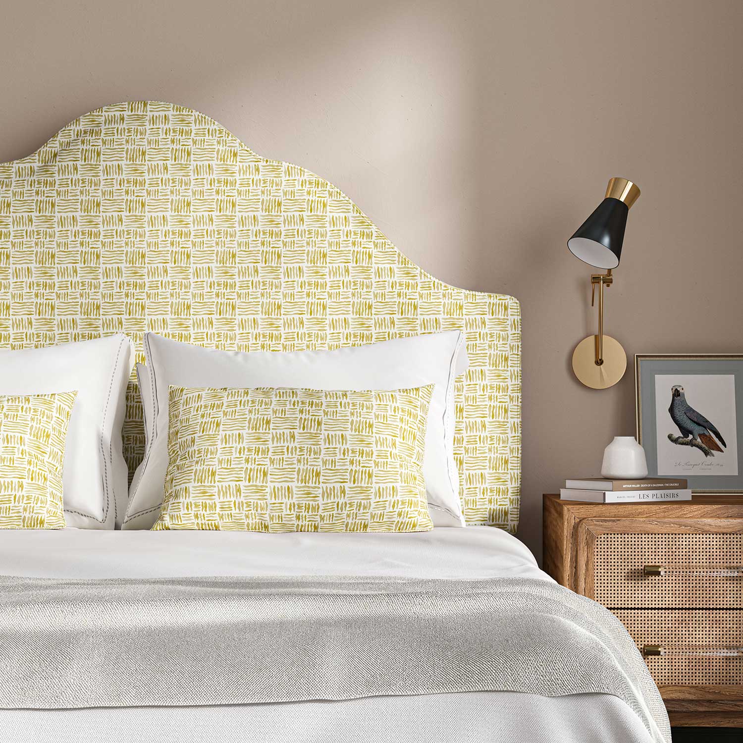 Headboard upholstered in a printed linen fabric in yellow and off white featuring a basketweave pattern.
