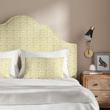 Headboard upholstered in a printed linen fabric in yellow and off white featuring a basketweave pattern.