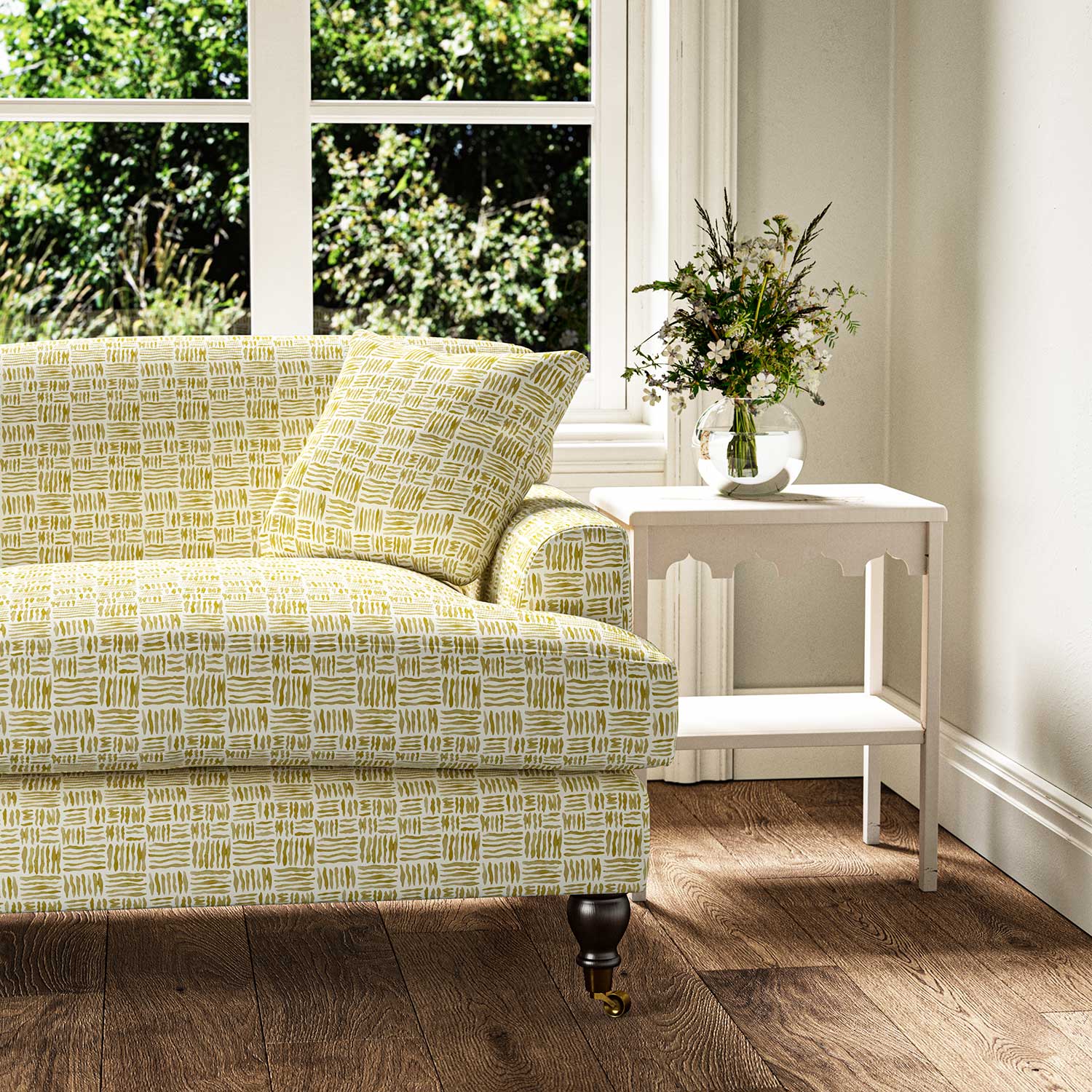 Sofa upholstered in a printed linen fabric in yellow and off white featuring a basketweave pattern.