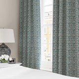 Curtains made from a printed linen fabric in blue and off white featuring a basketweave pattern.