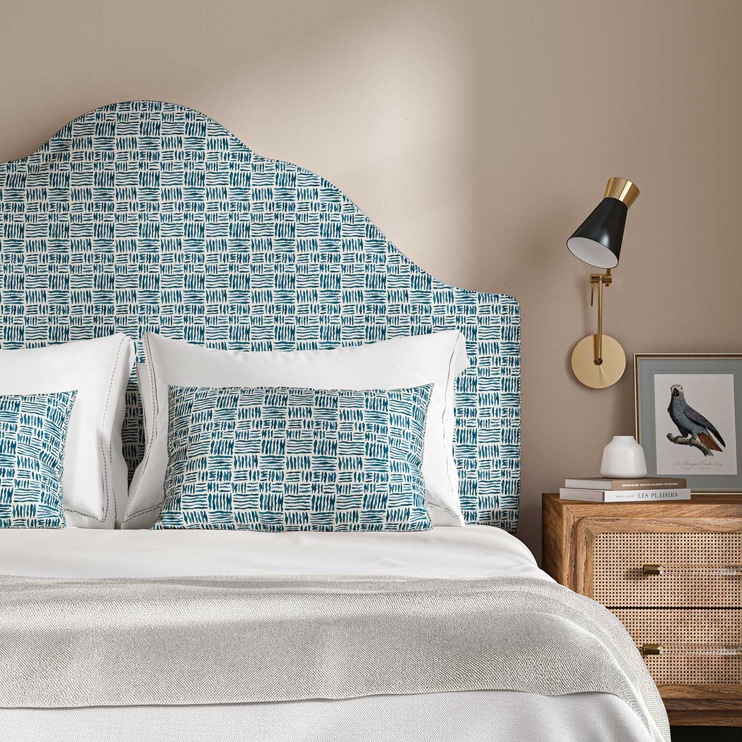 Headboard upholstered in a printed linen fabric in blue and off white featuring a basketweave pattern.