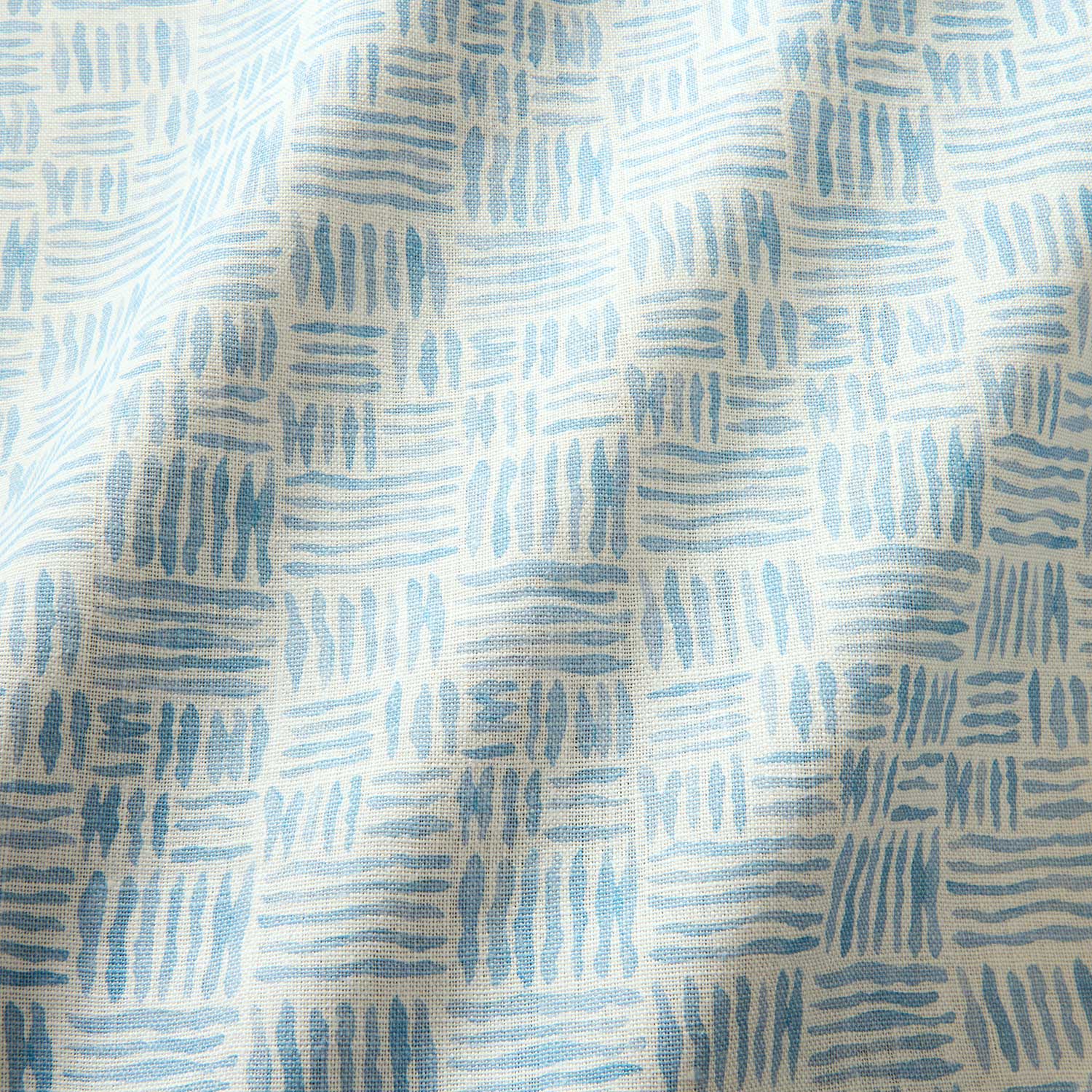 A printed linen fabric sample in blue and off white featuring a basketweave pattern.