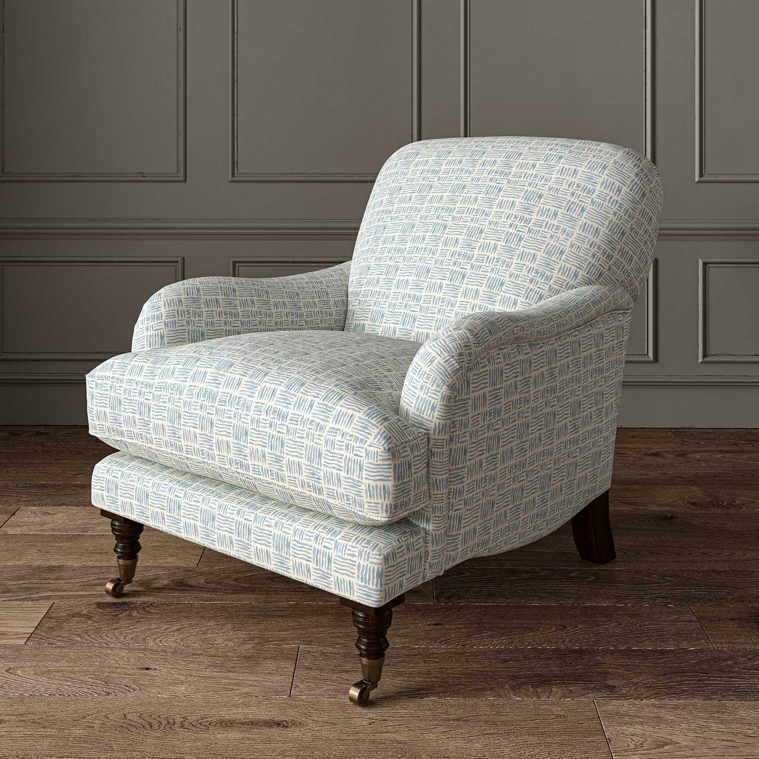 Chair upholstered in a printed linen fabric in blue and off white featuring a basketweave pattern.