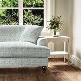 Sofa upholstered in a printed linen fabric in blue and off white featuring a basketweave pattern.