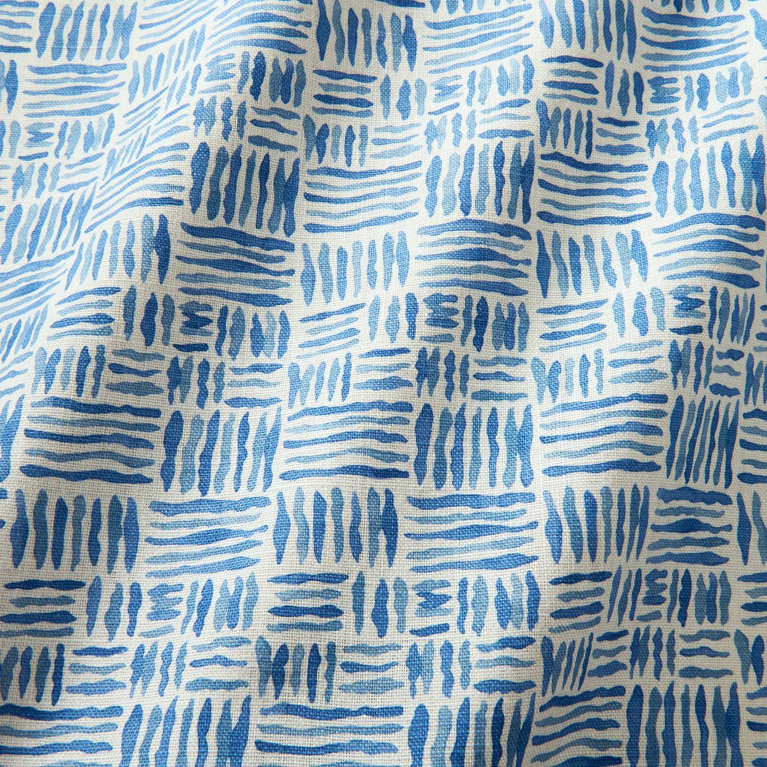 A printed linen fabric sample in blue and off white featuring a basketweave pattern.