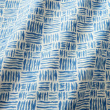 A printed linen fabric sample in blue and off white featuring a basketweave pattern.