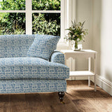 Sofa upholstered in a printed linen fabric in blue and off white featuring a basketweave pattern.