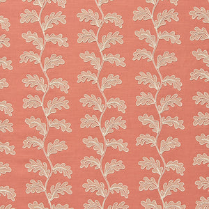 Decorative oakleaf embroidery on a coral background.