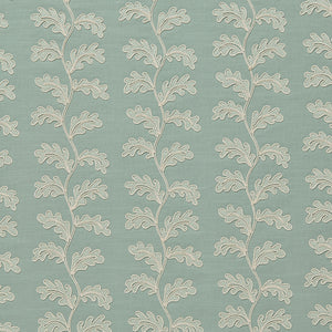 Decorative oakleaf embroidery on a blue background.