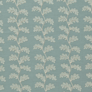 Decorative oakleaf embroidery on a blue background.