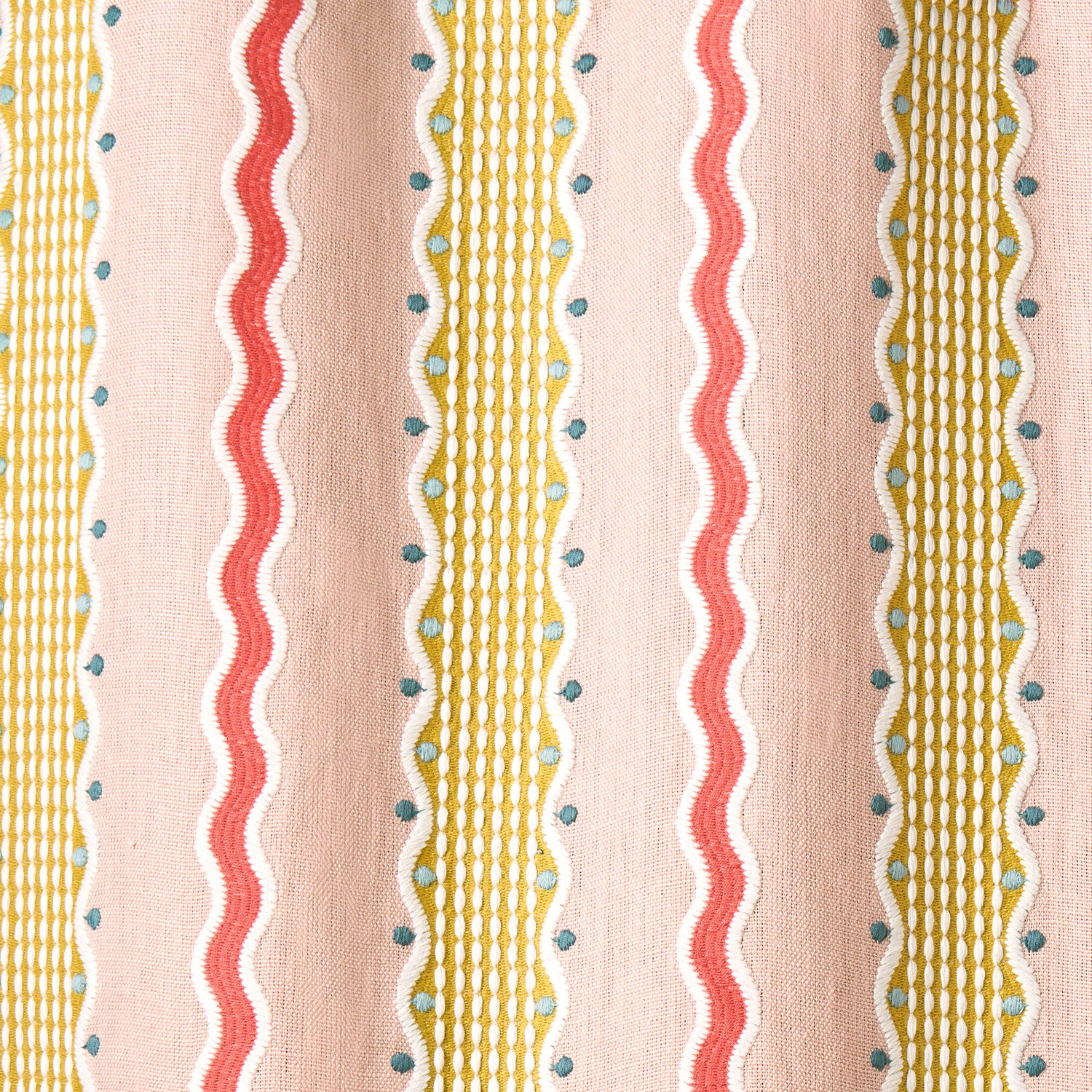 Embroidery fabric with wavy lines and small dots on a pink background.