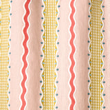 Embroidery fabric with wavy lines and small dots on a pink background.