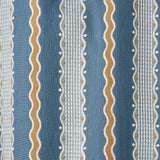 Embroidery fabric with blue, beige, and white stripes on a blue background.